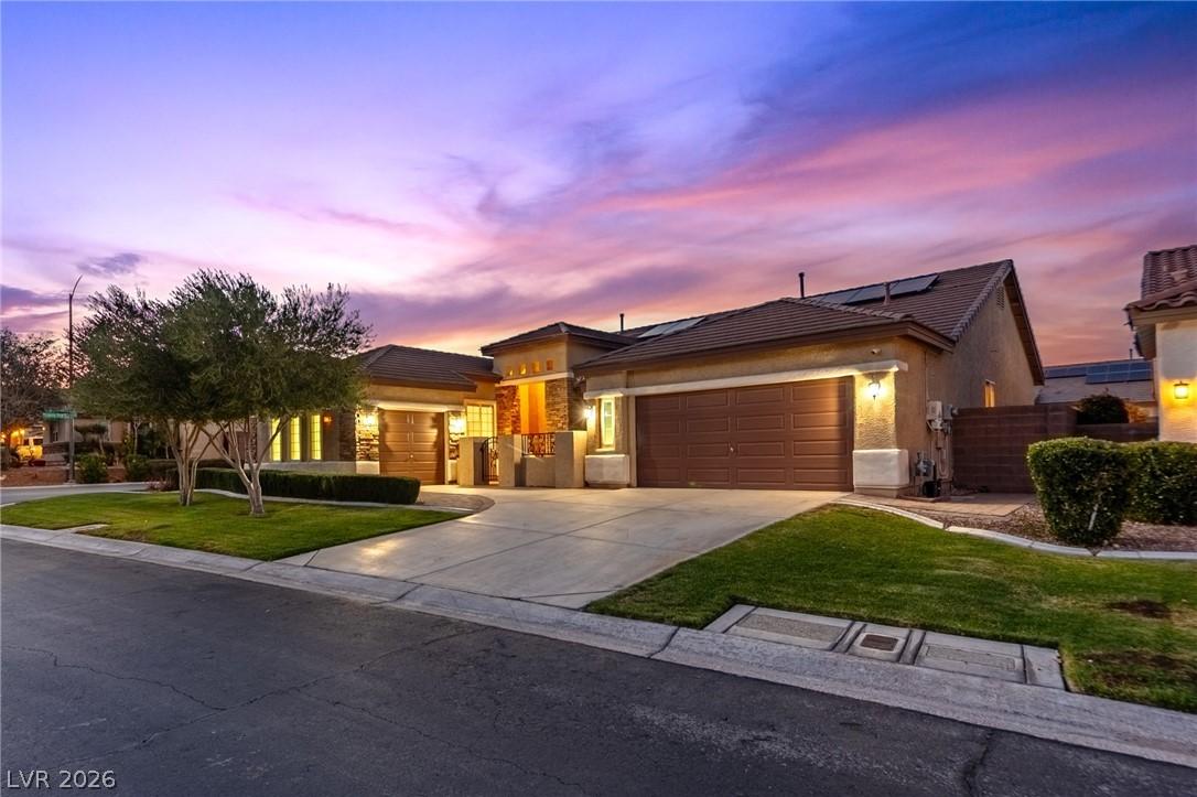 Image 1: View of front of property featuring an attached ga