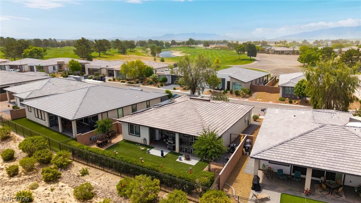 Image 1: Overlooking a verdant golf course, this contempora