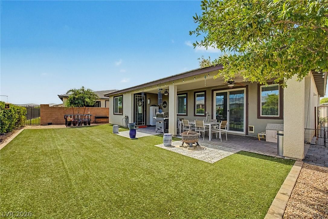 Image 3: A spacious backyard awaits, featuring a covered pa