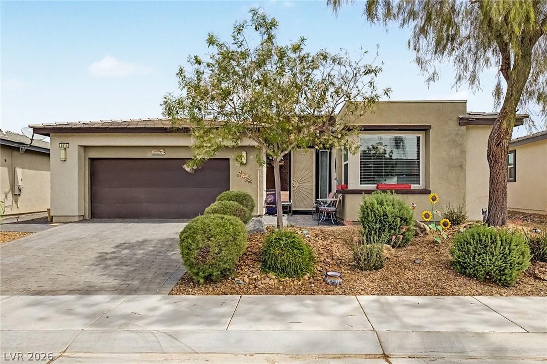 Image 4: An inviting entry and manicured landscaping grace