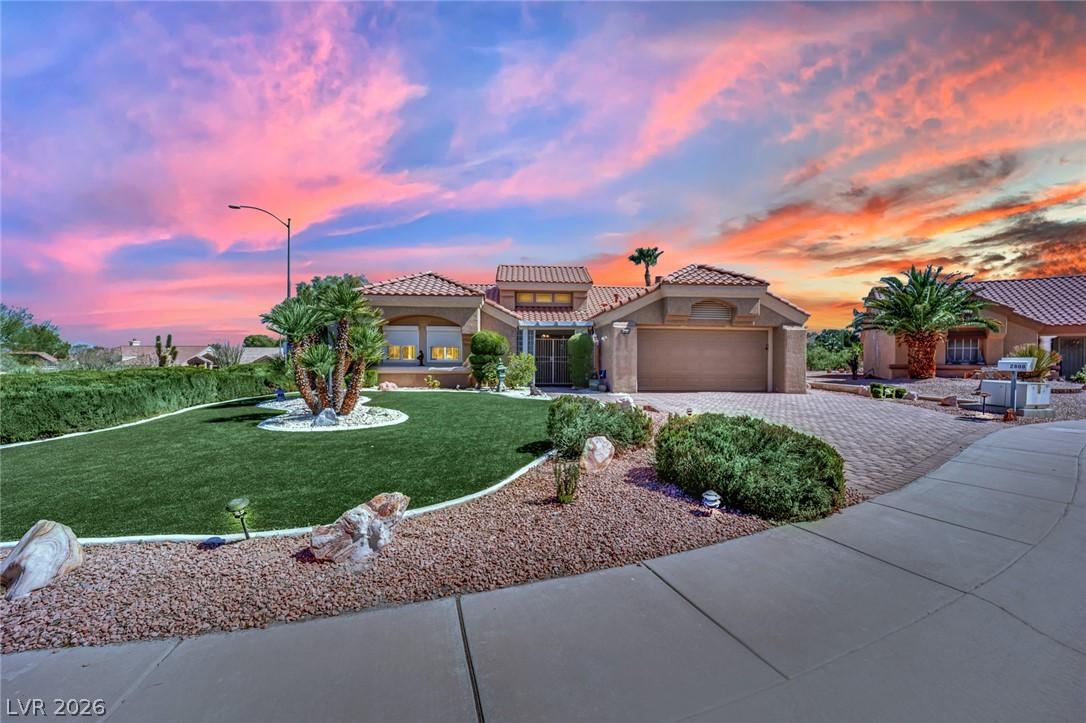Image 1: Dramatic sunset hues enhance this home's impressiv