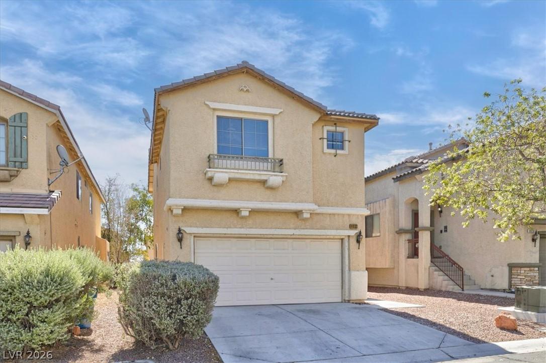 Image 3: A charming stucco home with an integrated garage p
