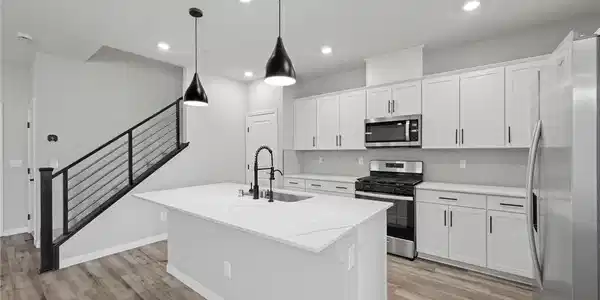 Image 4: Clean lines and a spacious center island define th