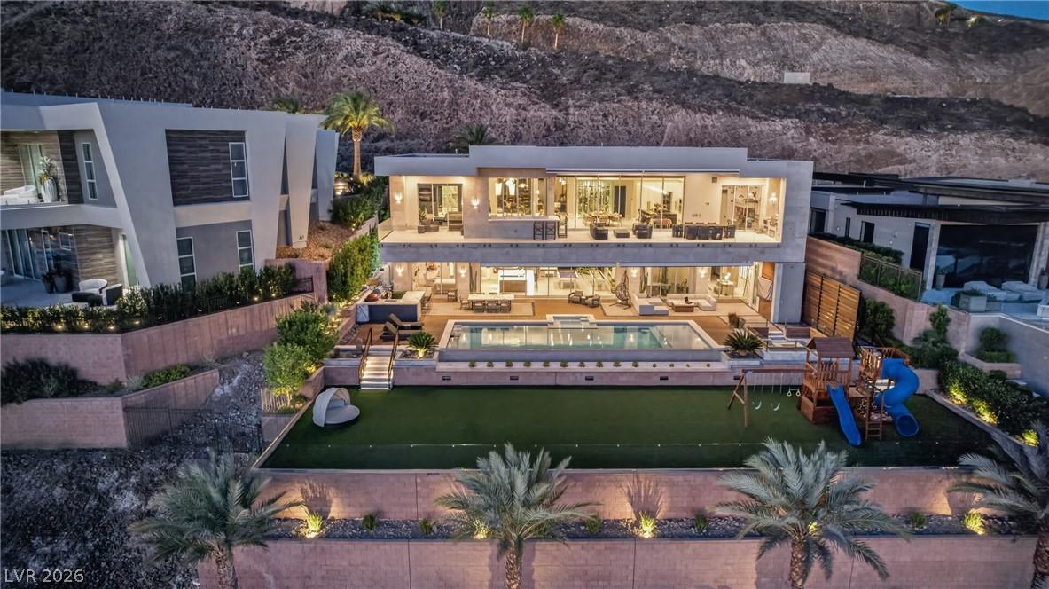 Image 1: An opulent, multilevel residence graces a hillside
