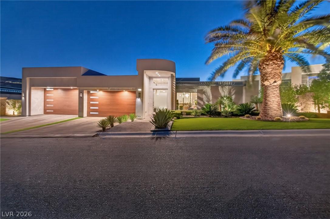 Image 3: A modern architectural entrance and landscaping.