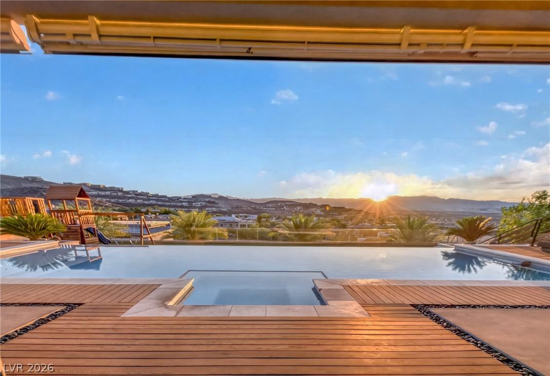 Image 4: An inviting infinity pool and deck offer serene mo