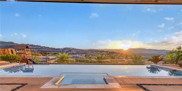 Image 4: An inviting infinity pool and deck offer serene mo