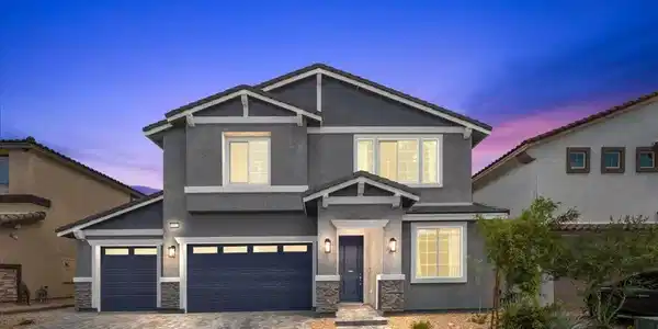 Image 2: A striking gray two-story residence with dark blue