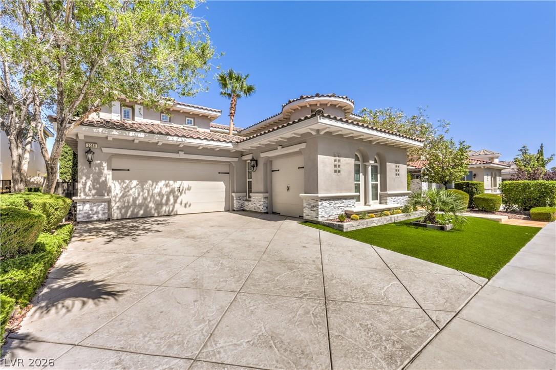 Image 3: A spacious driveway and lush artificial turf welco