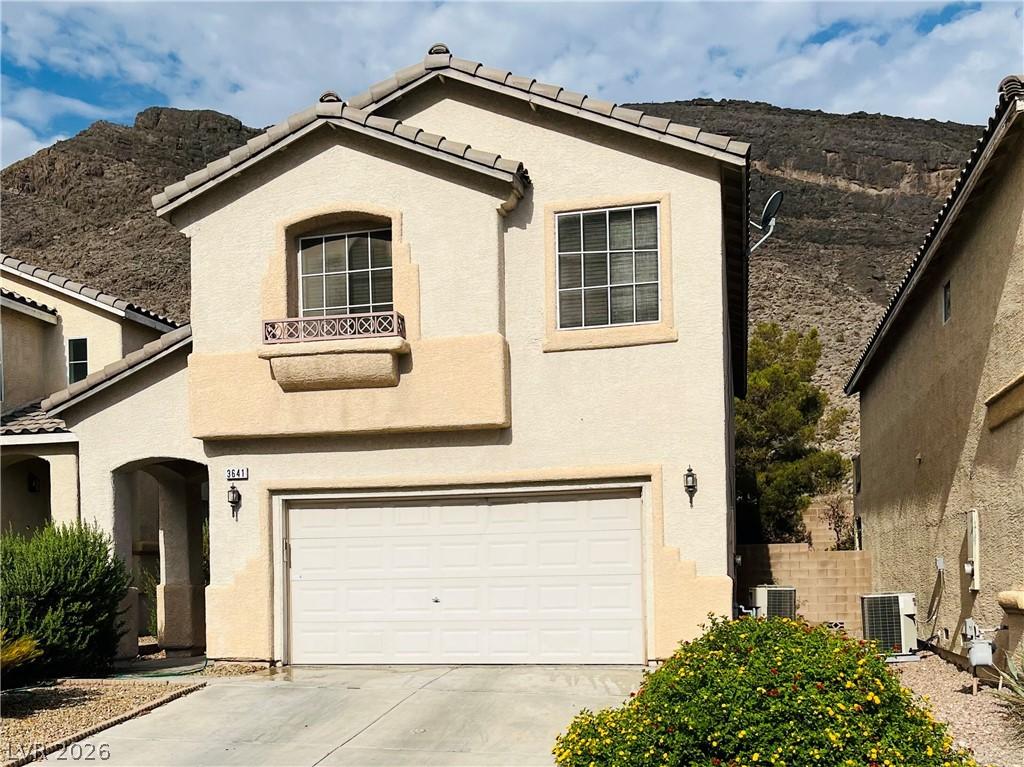 Image 3: A cream-colored stucco residence presents a welcom