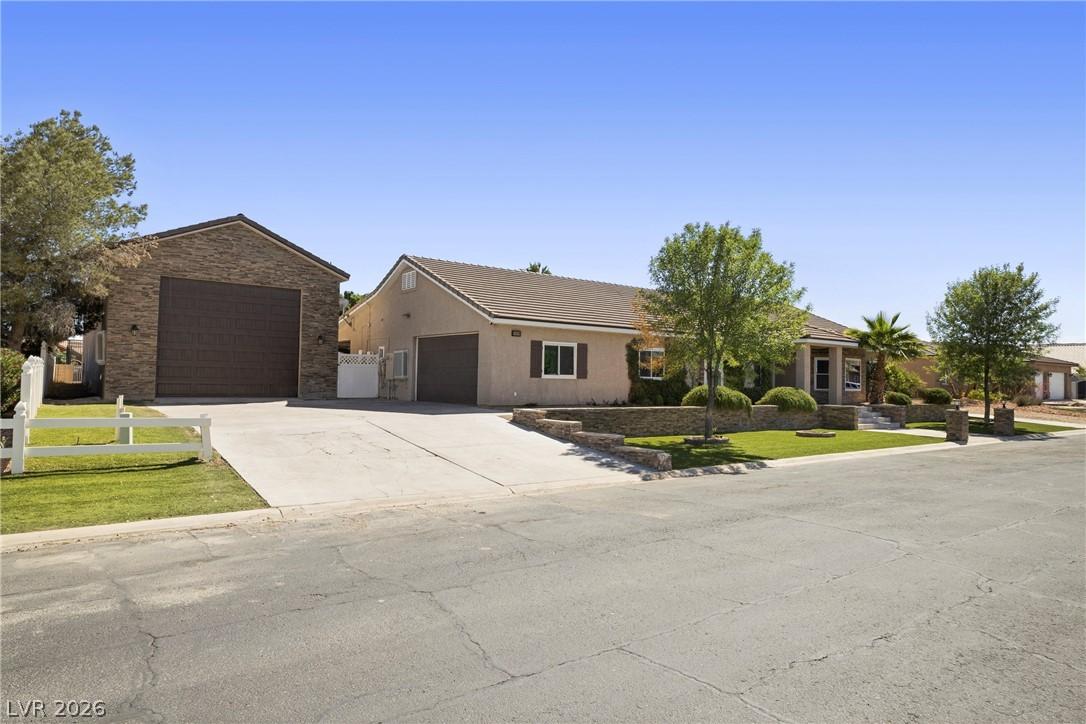 Image 3: A split driveway leads to a welcoming home featuri