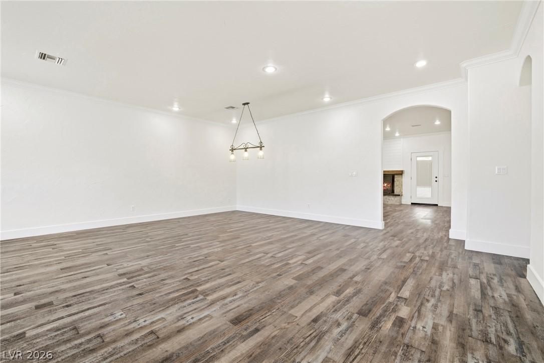 Image 4: An open floorplan with durable flooring extends to