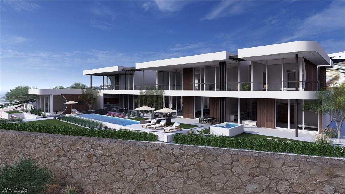 Image 2: A striking modern residence boasts an inviting poo