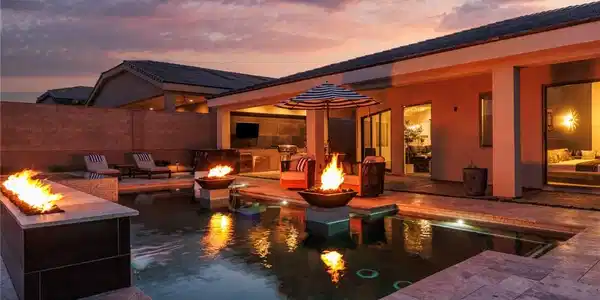 Image 2: An inviting backyard oasis features a shimmering p
