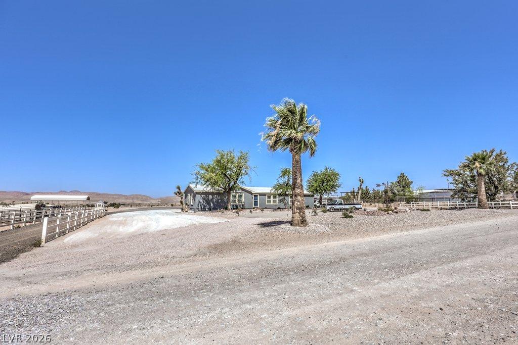 Image 3: A rural retreat with desert landscaping and clear