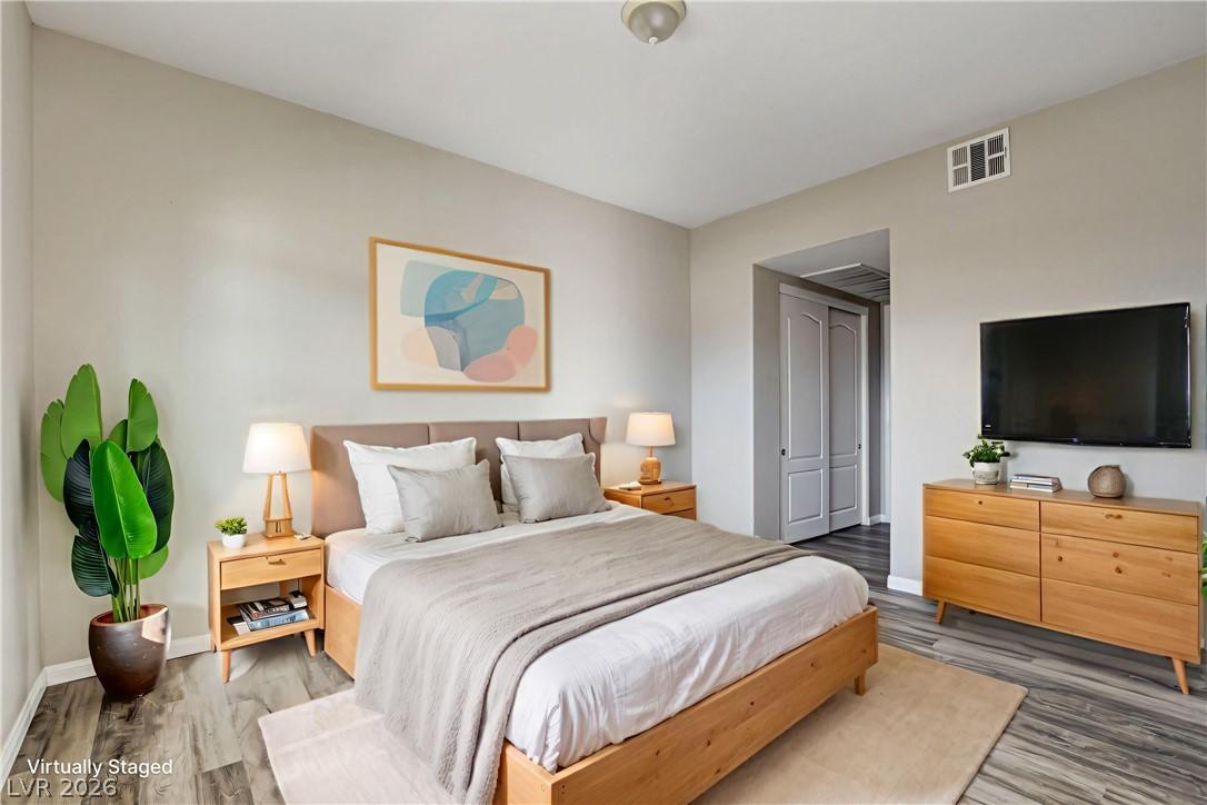 Image 3: Relax in this tranquil bedroom, featuring a large