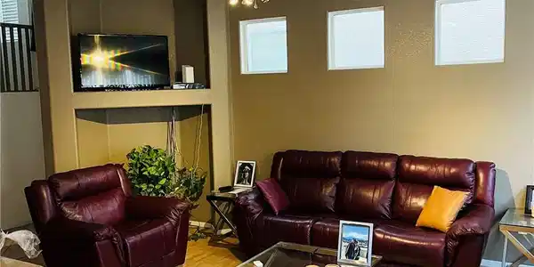 Image 4: A welcoming living area showcases a built-in media