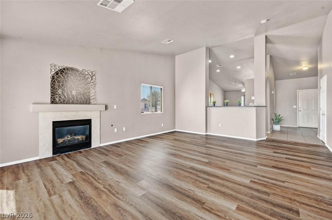 Image 3: A welcoming living space features warm wood-look f