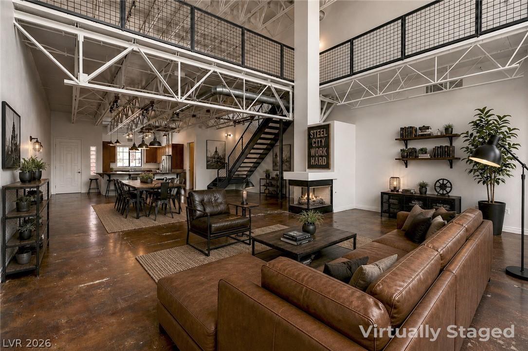 Image 4: Open concept living space features high ceilings,