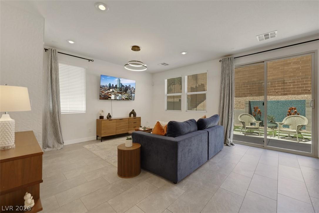 Image 2: Bright and airy living room with sleek tile floori