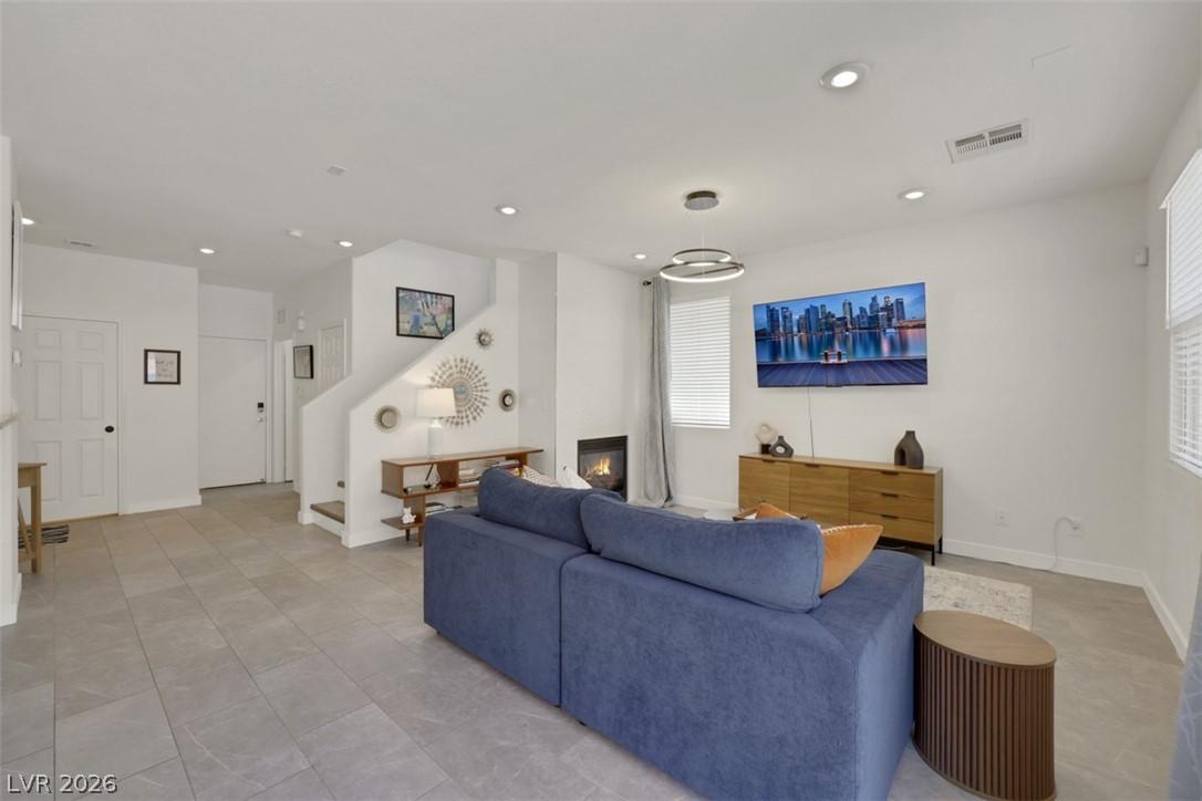 Image 3: This bright living space features a stylish firepl