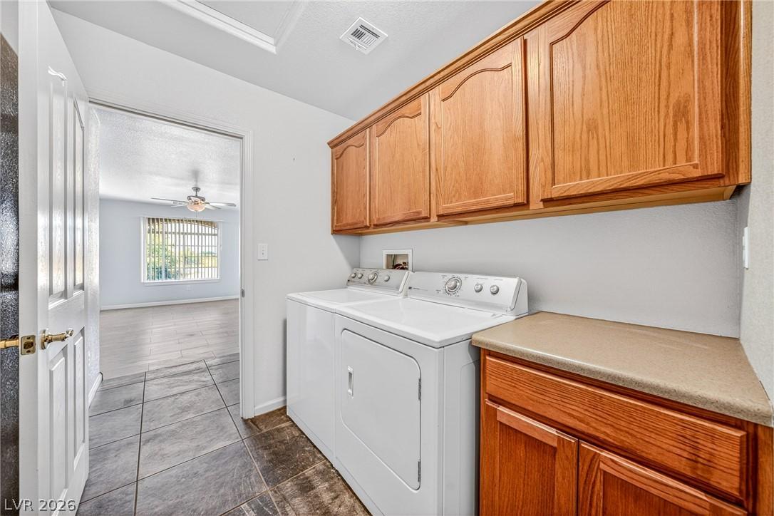Image 4: Functional laundry space featuring durable tile fl