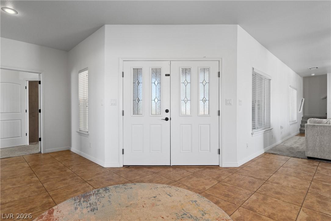 Image 4: A welcoming entry features decorative glass panel