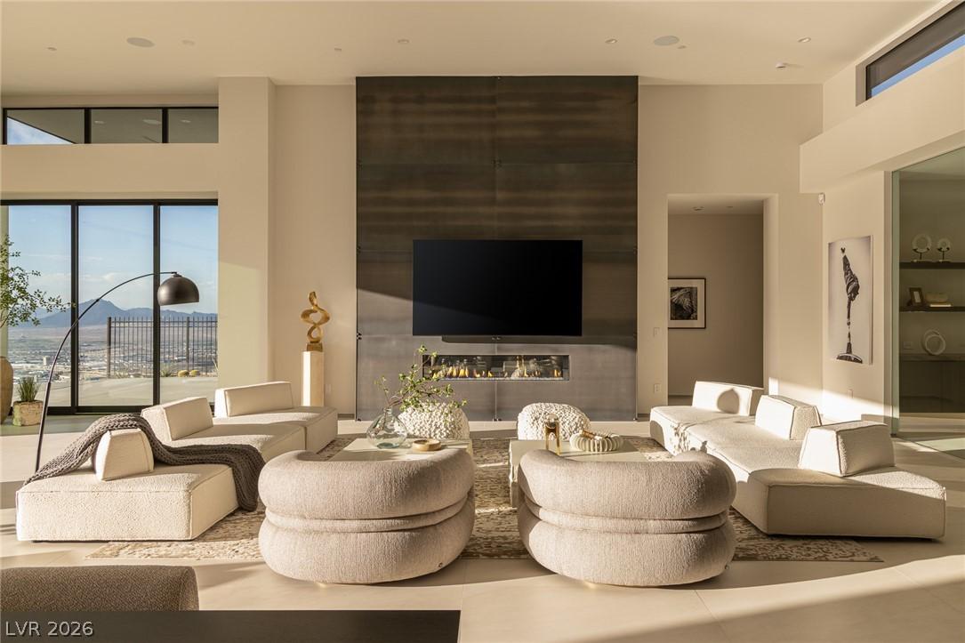 Image 4: A refined great room with a linear fireplace and t