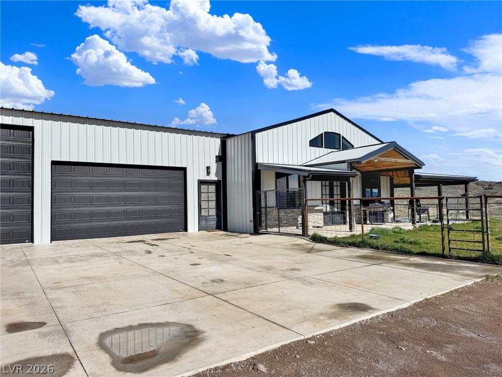 Image 1: Modern barn-style residence featuring a prominent