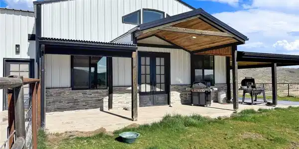 Image 2: A modern facade with corrugated siding offers a we