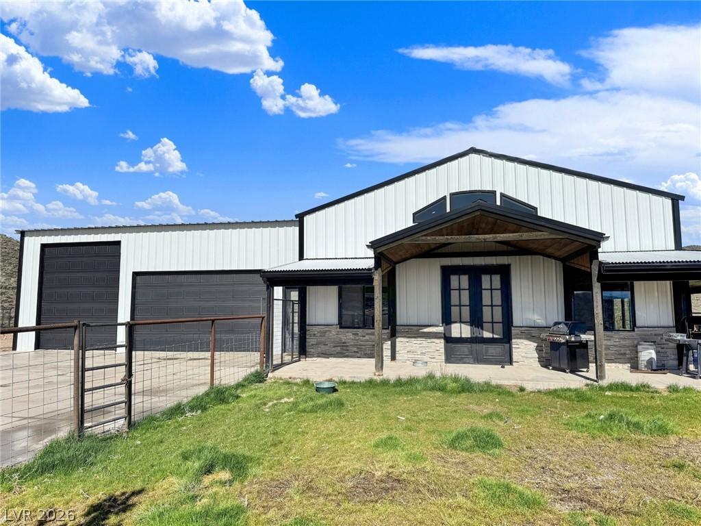 Image 3: A modern barn-style home features an inviting cove