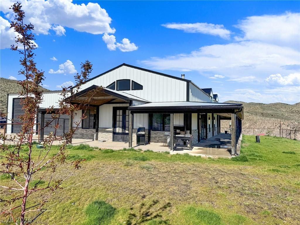 Image 4: A striking modern farmhouse with expansive covered