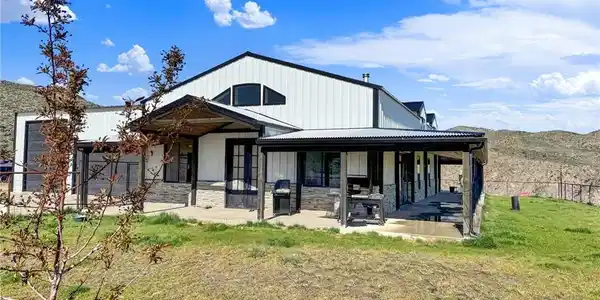 Image 4: A striking modern farmhouse with expansive covered