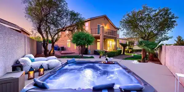 Image 4: An inviting backyard oasis offers a sparkling spa