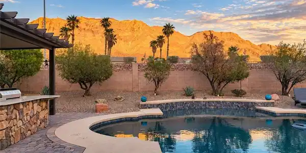 Image 3: Dramatic mountain views frame this backyard oasis