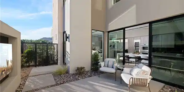 Image 3: An inviting outdoor patio extends from a modern re