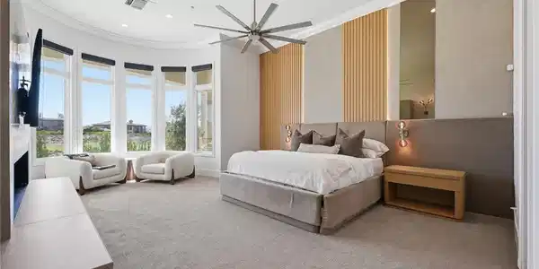 Image 4: Retreat to the primary suite, where a gas fireplac