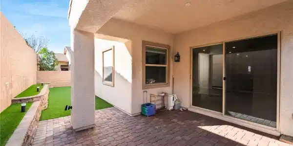 Image 3: Fenced backyard with a patio