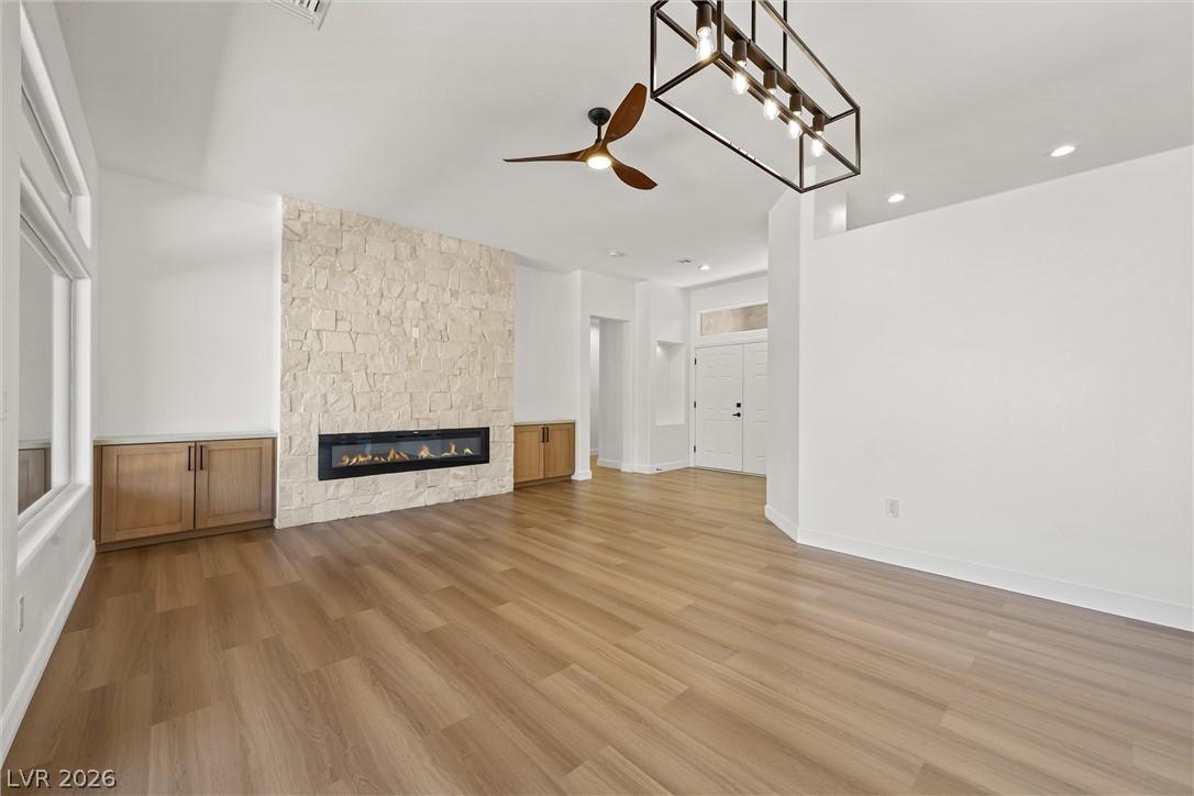 Image 2: A refined living area presents a sleek fireplace s