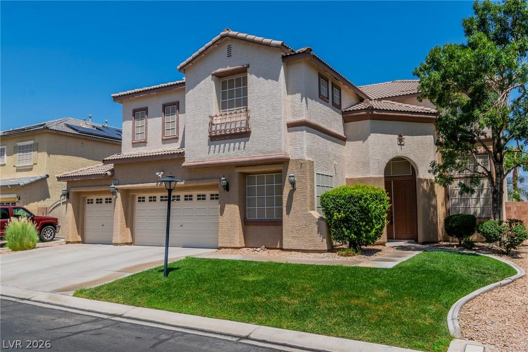Image 1: A well-kept front yard and inviting entry highligh