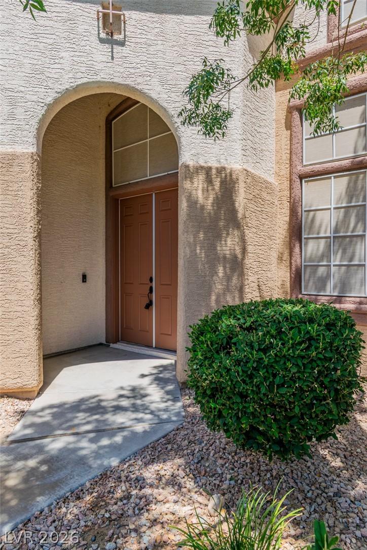 Image 3: An inviting arched entryway with double doors welc
