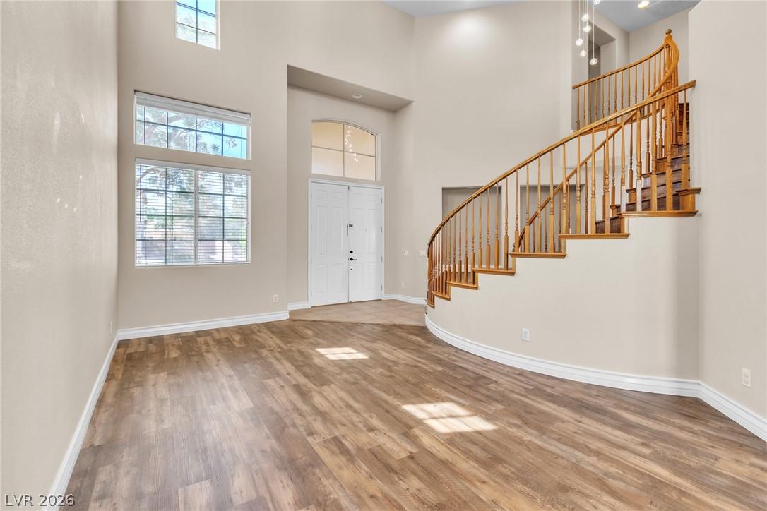 Image 4: A grand entry with soaring ceilings and a sweeping
