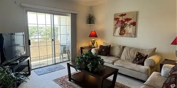 Image 3: This living area offers comfort and ample natural