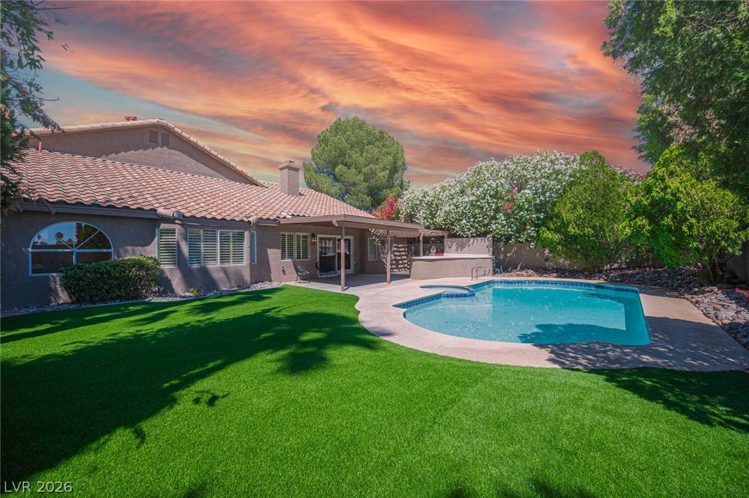 Image 2: An inviting backyard oasis awaits with a sparkling