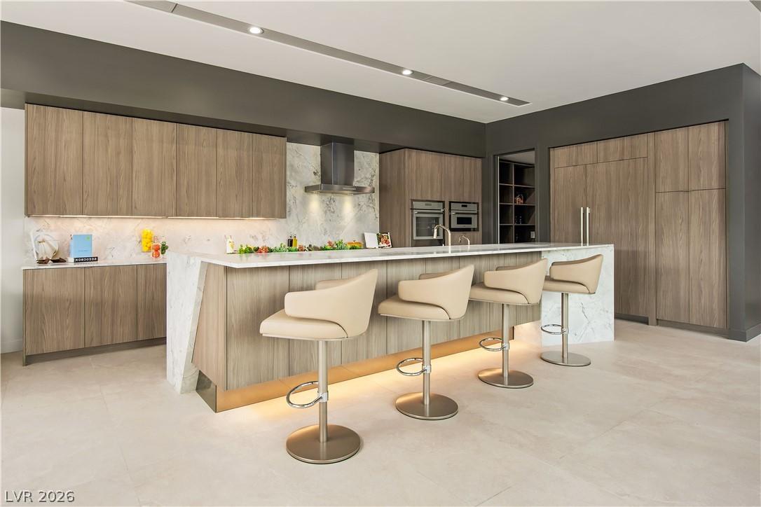 Image 3: A sleek modern kitchen offers streamlined cabinetr