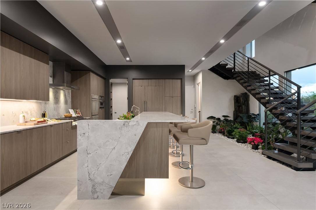 Image 4: Marble waterfall island and contemporary cabinetry