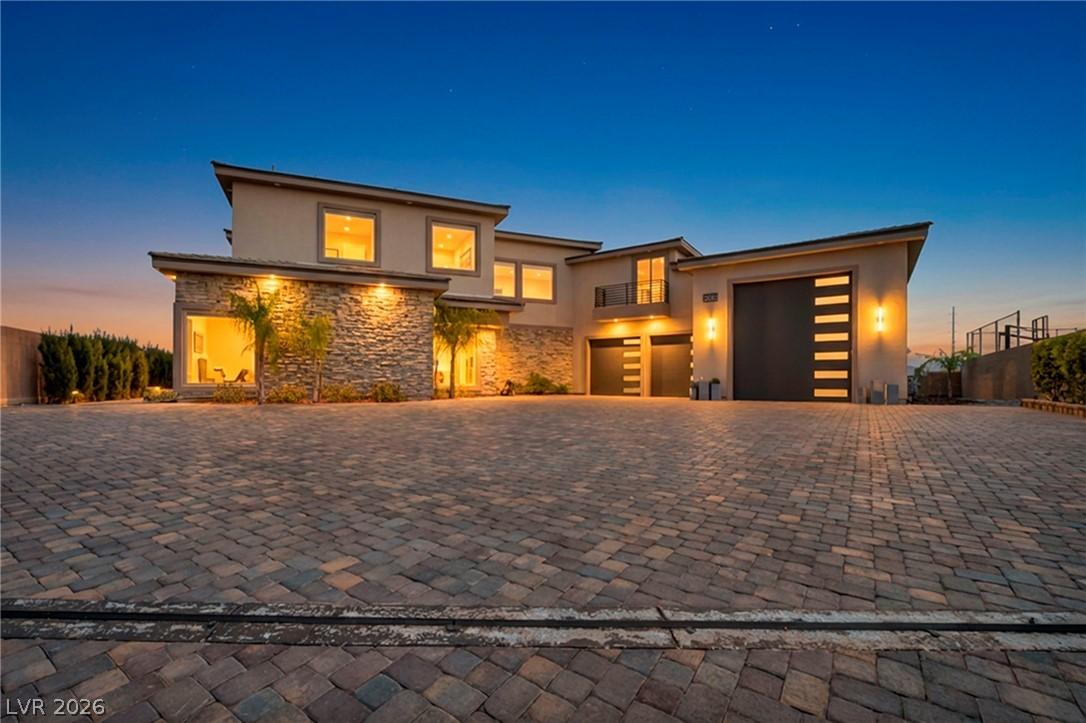 Image 1: Prairie-style home featuring stone siding, stucco