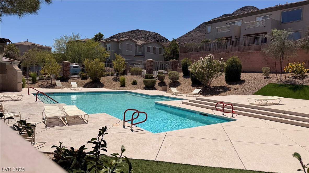 Image 2: A refreshing outdoor pool with comfortable lounge