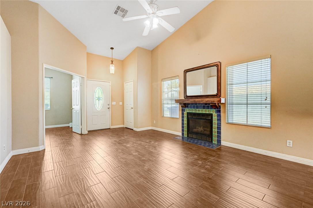 Image 2: A striking fireplace with colorful tile accents an