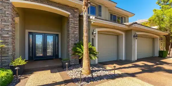 Image 3: Stone accents frame the grand entrance, offering a